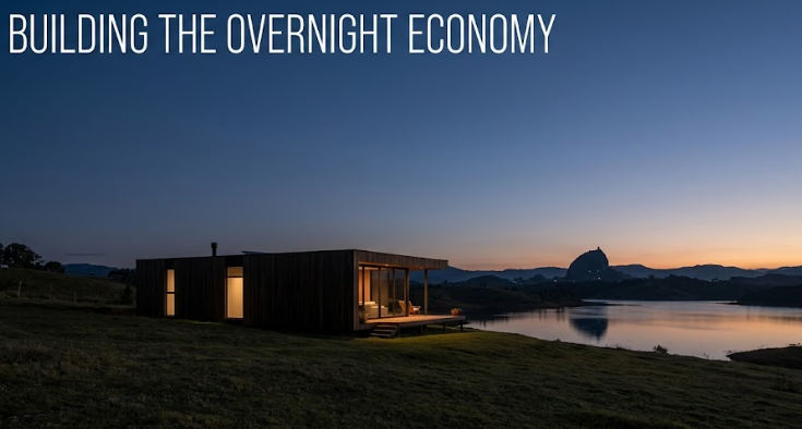 Modern eco-resort cabin overlooking the reservoir at dusk with La Piedra in the distance